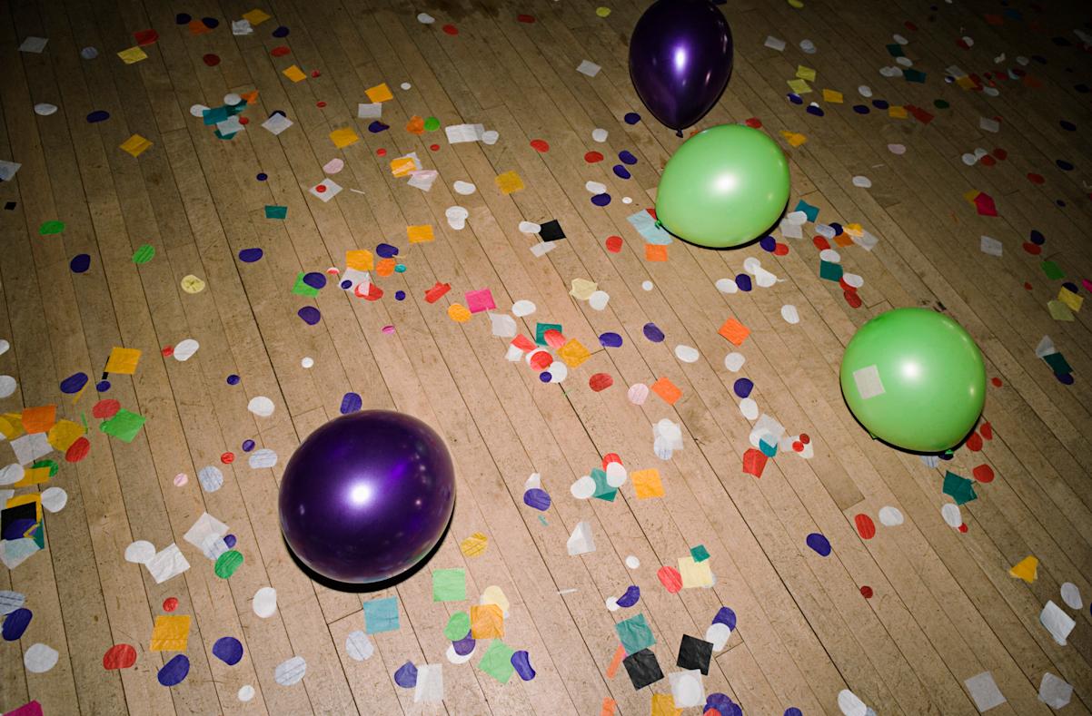 Empty dance floor except for confetti and balloons