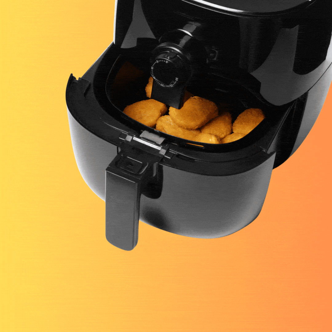 A robot hand reaches for an air fryer full of chicken nuggets. 