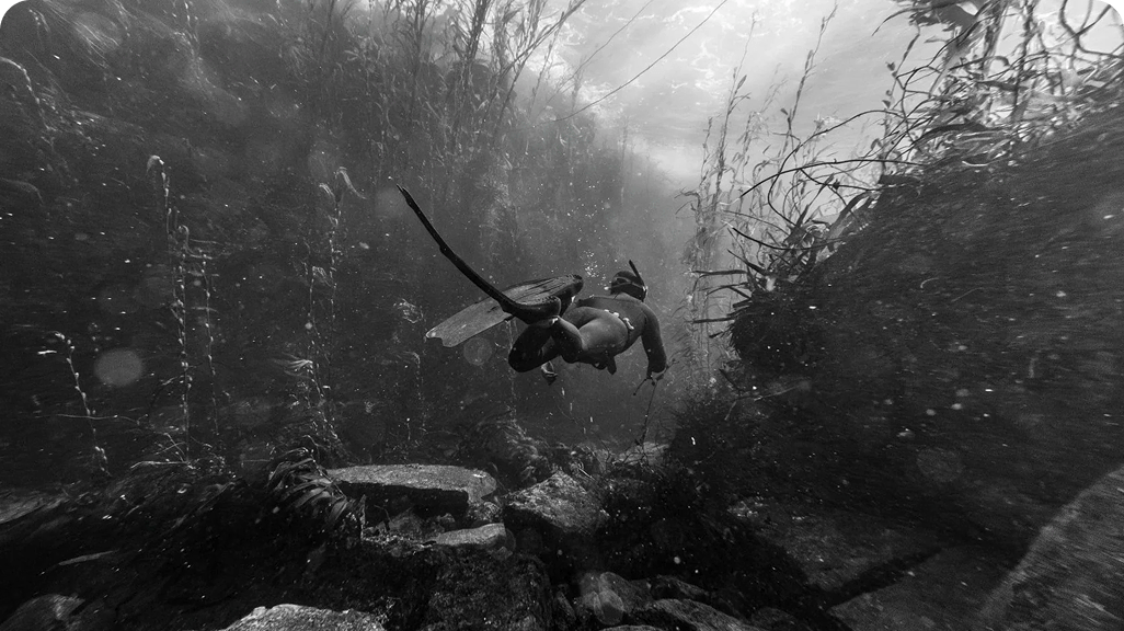 Two people hike across a snowy landscape on skis.