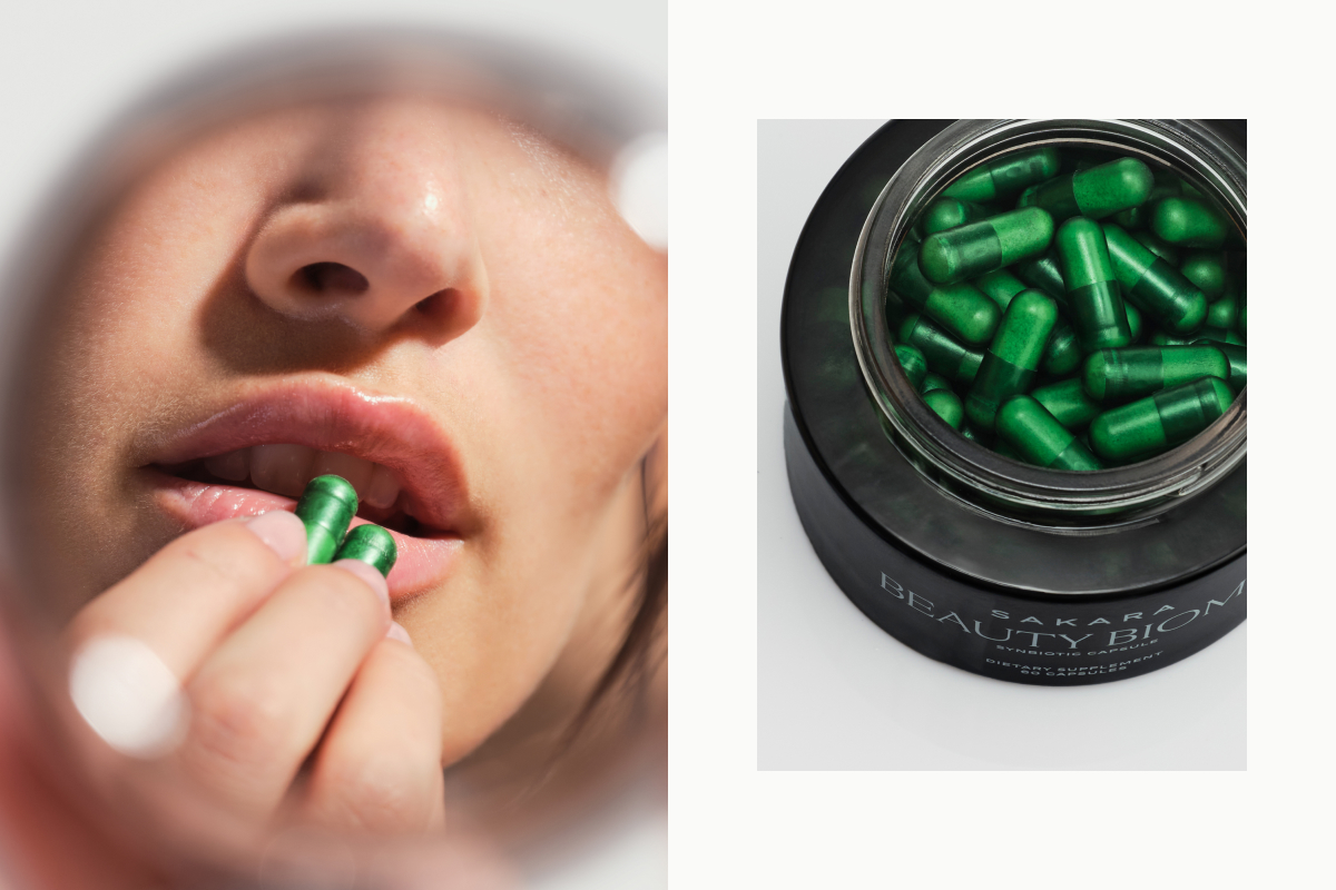 A woman holding two green Beauty Biome capsules to her lips, alongside an open jar of Sakara Beauty Biome synbiotic capsules